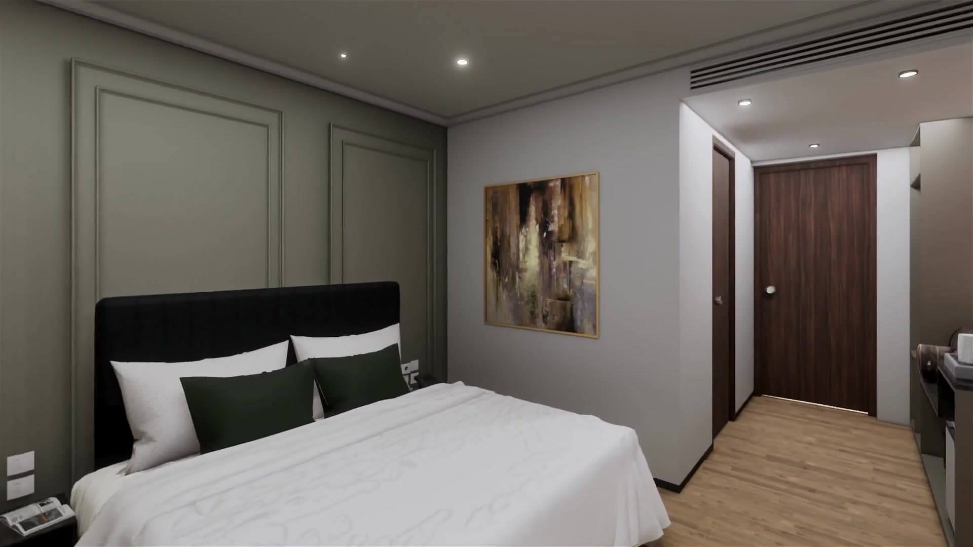 Deluxe room interior with king bed and green panelled wall